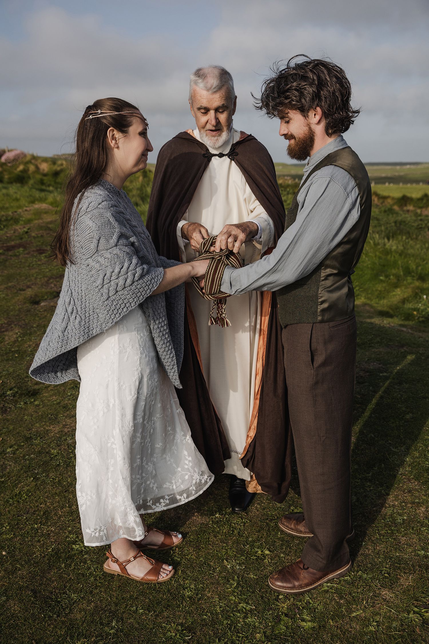 Handfasting ceremony at sunset overlooking the Atlantic Ocean at the Cliffs of Moher in May