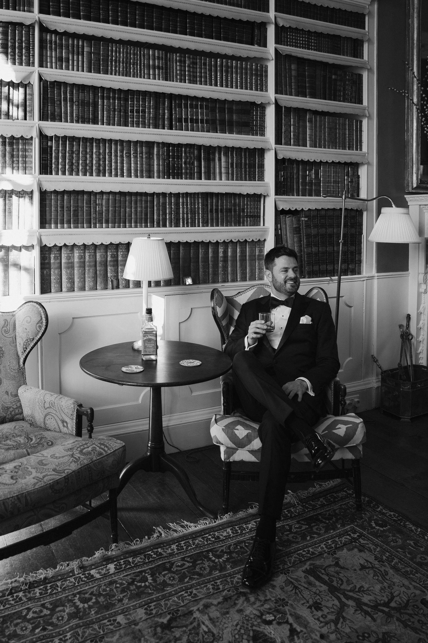 groom sat drinking a whiskey in the library at Iscoyd park