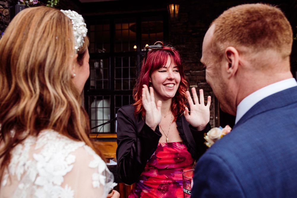 A sequence of candid wedding celebration photos showing guests dancing and interacting at an indoor reception venue.