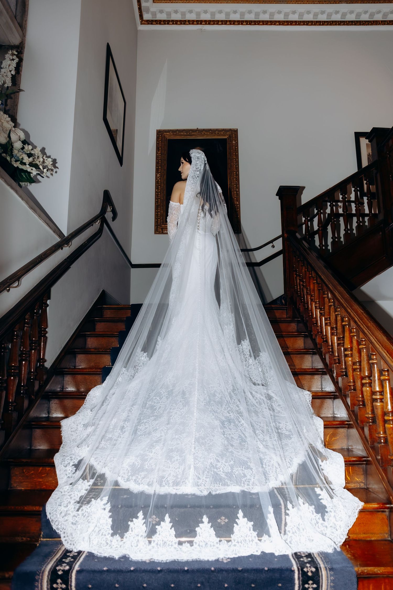 A wedding dress train cascades elegantly down wooden stairs in a sequence of five similar photos.