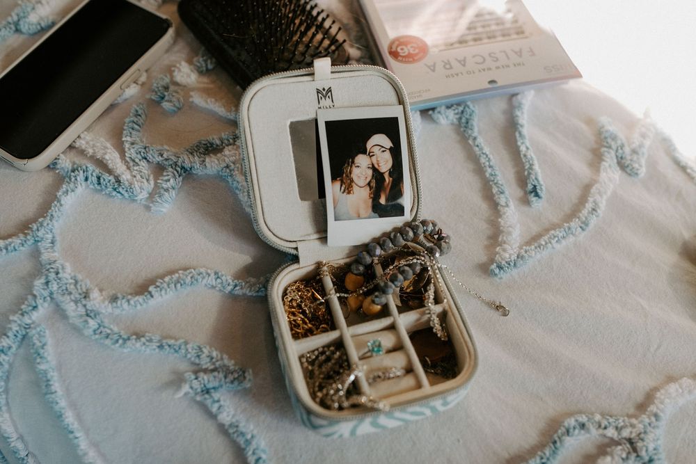 Wedding details including jewelry and decorative elements in soft blue tones.