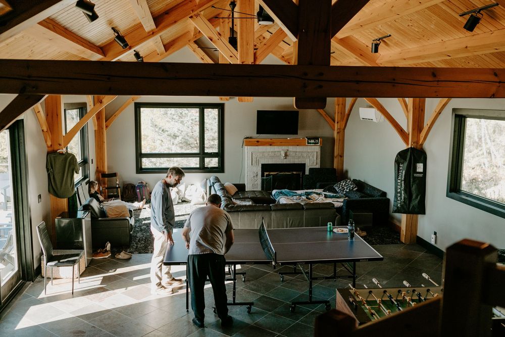 Modern rustic interior space with exposed wooden beams and minimalist furniture.