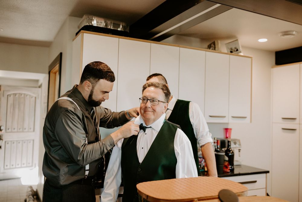 Wedding preparation scene showing formal attire and getting ready activities indoors.