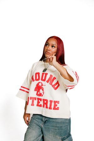 Woman in white t-shirt with red text and blue jeans poses in multiple casual positions against white background.