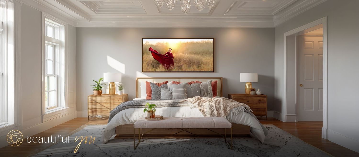 Elegant master bedroom with a stunning and powerful portrait of an expectant mom in a gorgeous red dress at sunset featured on the wall.