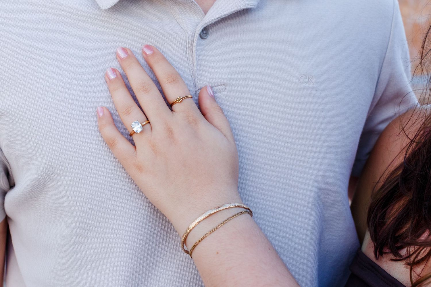 Ring shot - woman's hand on man's chest. Old San Juan, Puerto Rico.