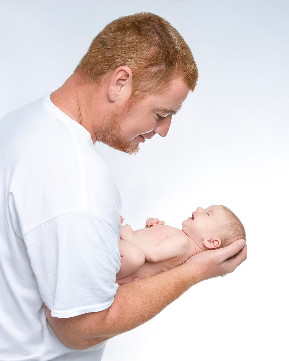 newborn baby girl with parents soft light Lakewood ranch family studio portrait emotional connection natural calm moment