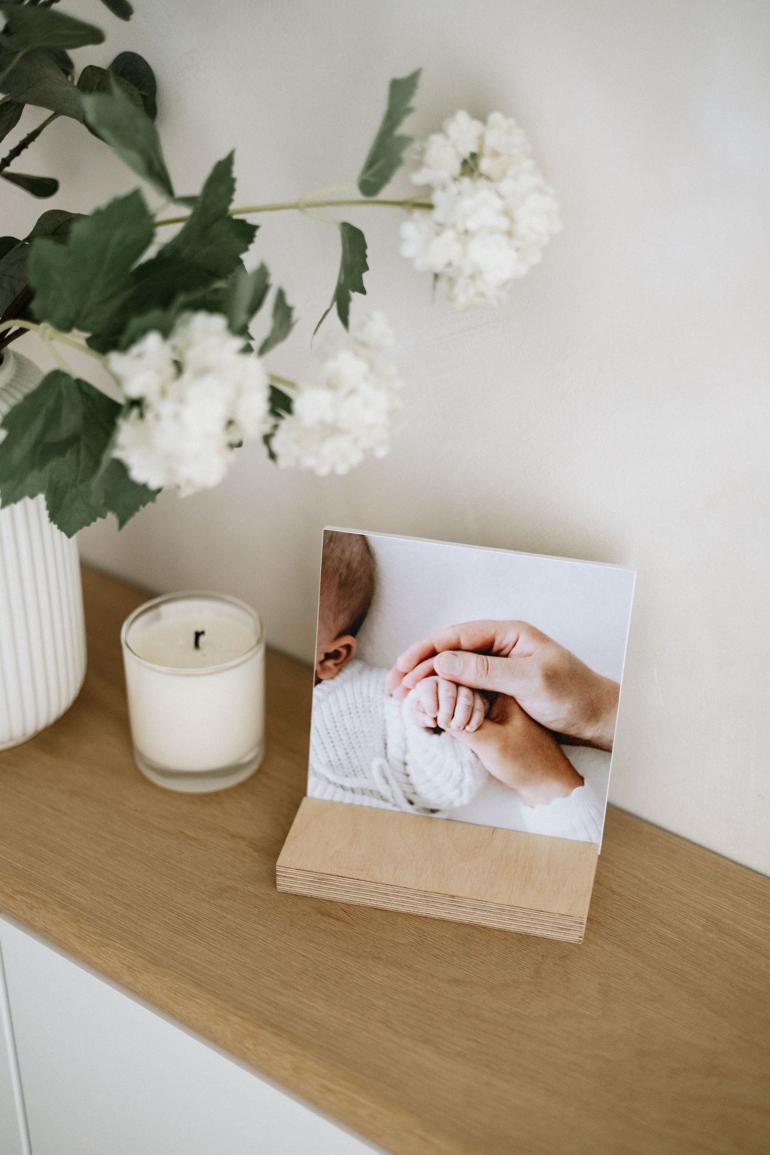 A wooden photo stand displaying a newborn baby photo Nottingham natural newborn and family photographer
