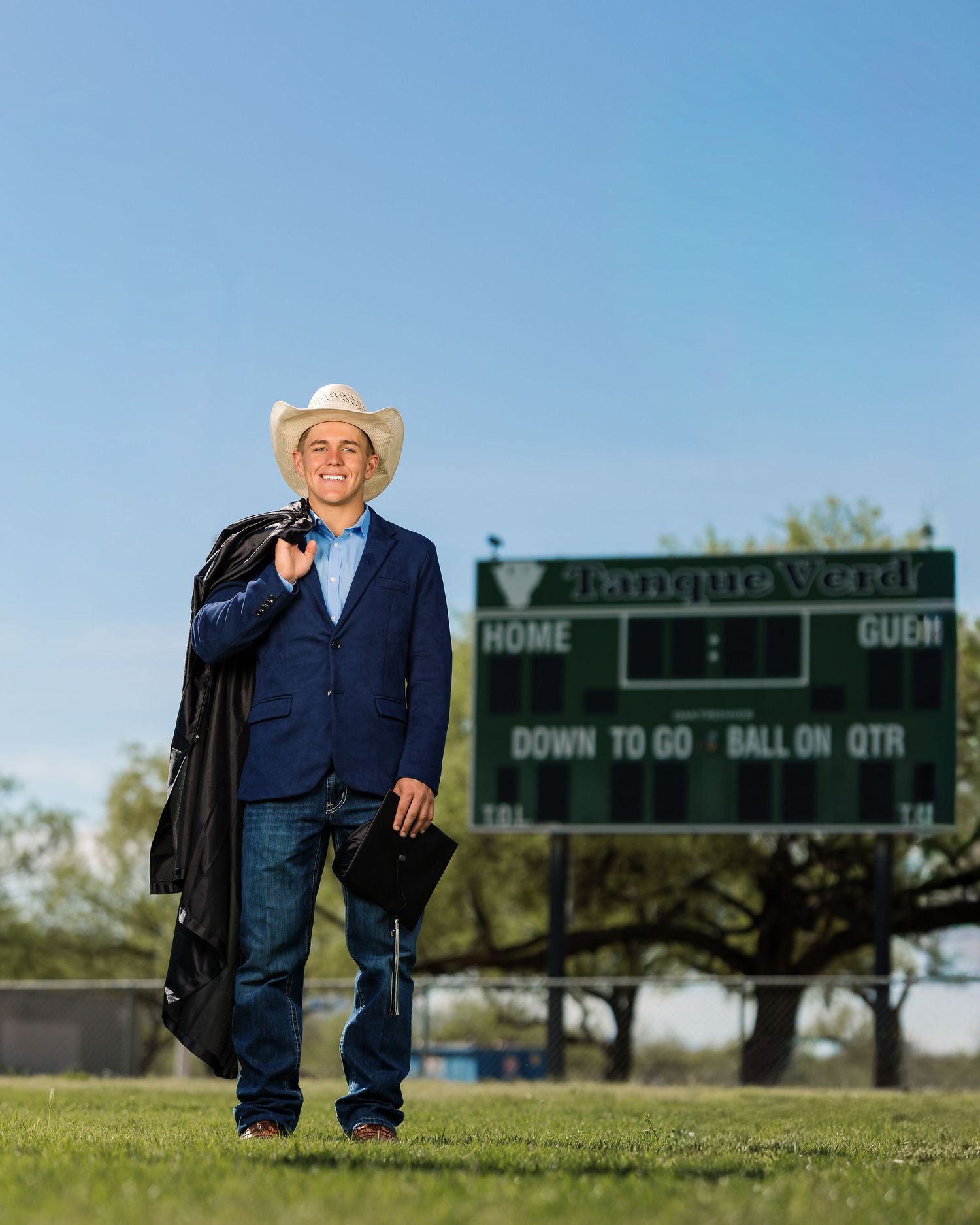 High school senior guy on a football field in Tucson, photographed by Tucson Senior Photographer