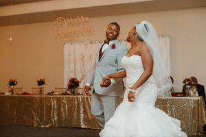 Bride and groom share joyful first dance at wedding reception.