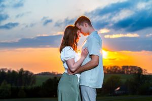 A romantic sunset portrait of a couple embracing outdoors.