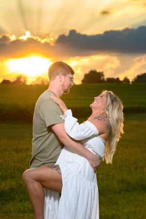 Romantic sunset photo in field with dramatic golden sky.