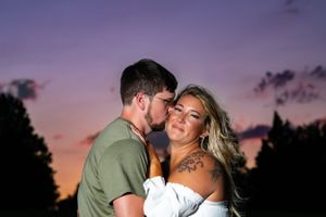 Intimate portrait at twilight with purple sky backdrop.