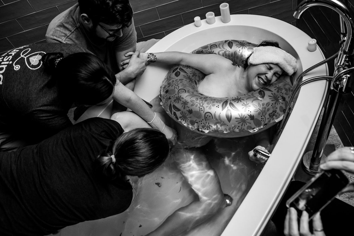 Black and white image of a mother pushing during a water birth