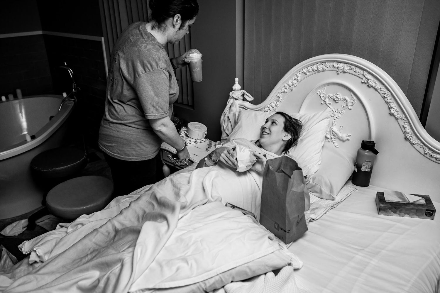 Black and white photograph capturing tender moments after a birth center birth experience