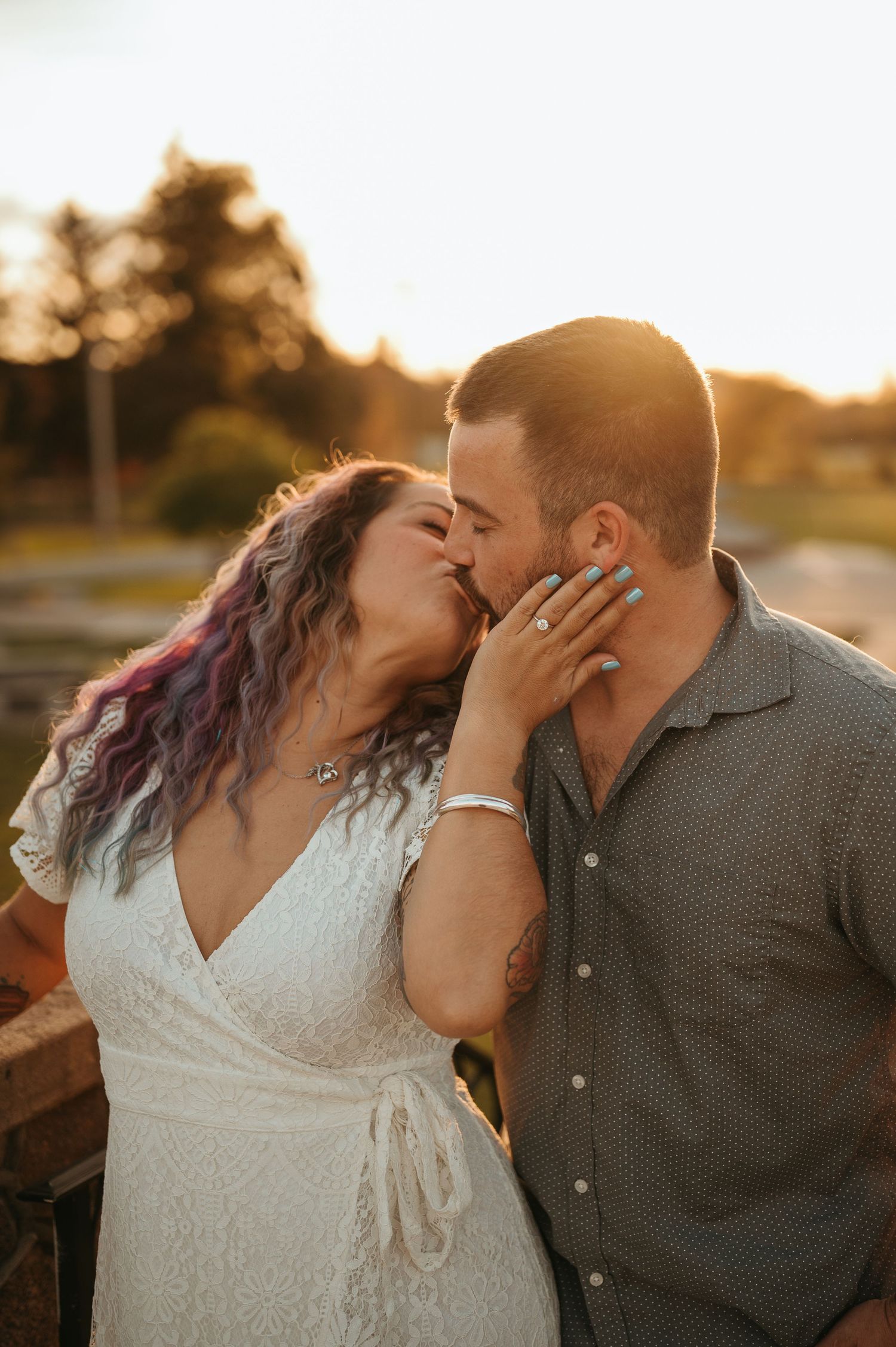 Intimate romantic moment between couple during golden sunset light.