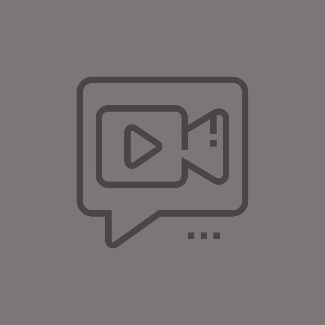 A simple grey chat bubble icon with a video player symbol inside, representing video messaging or chat functionality.