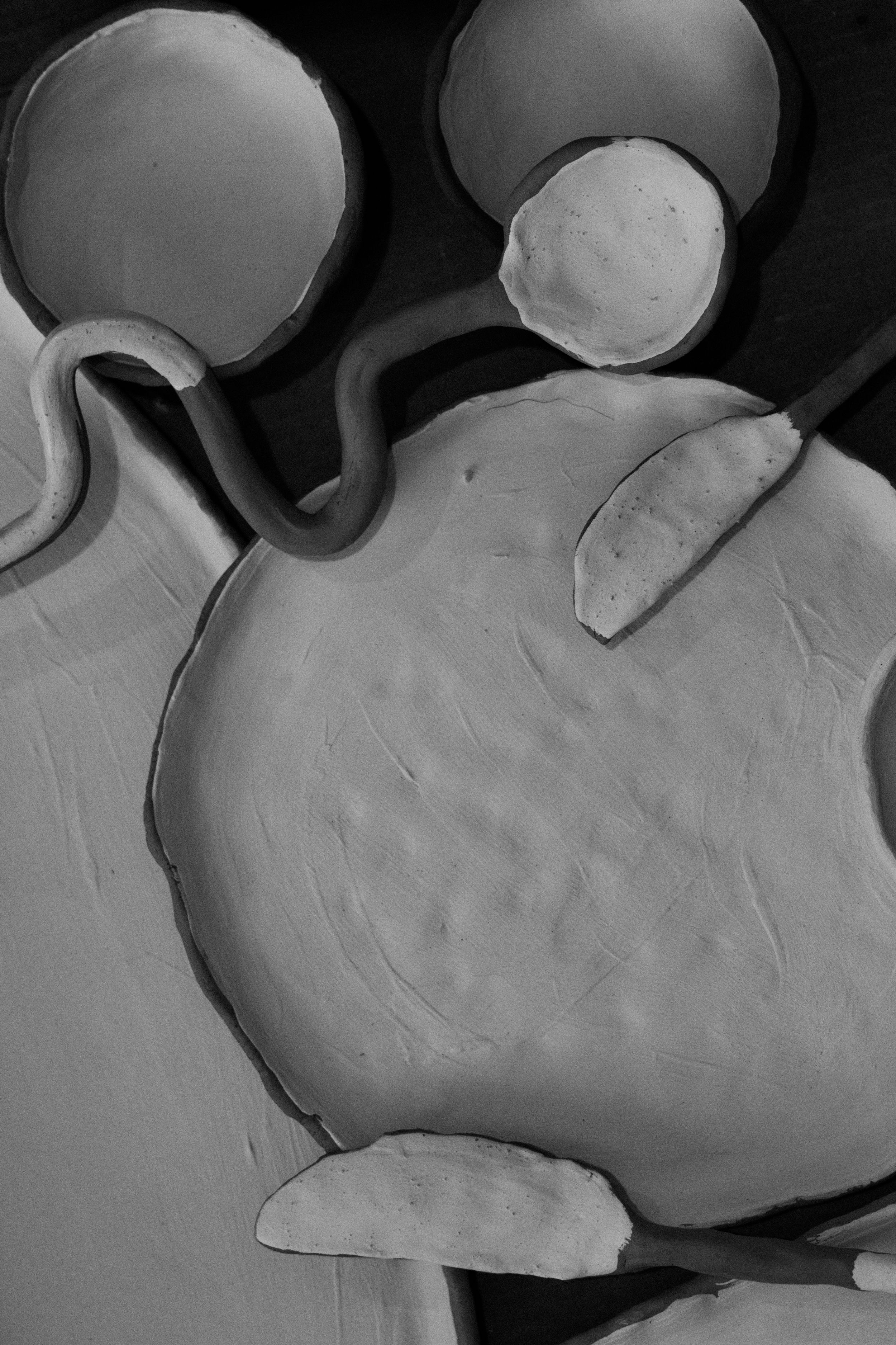 Overhead view of clay pottery pieces in various stages of formation.