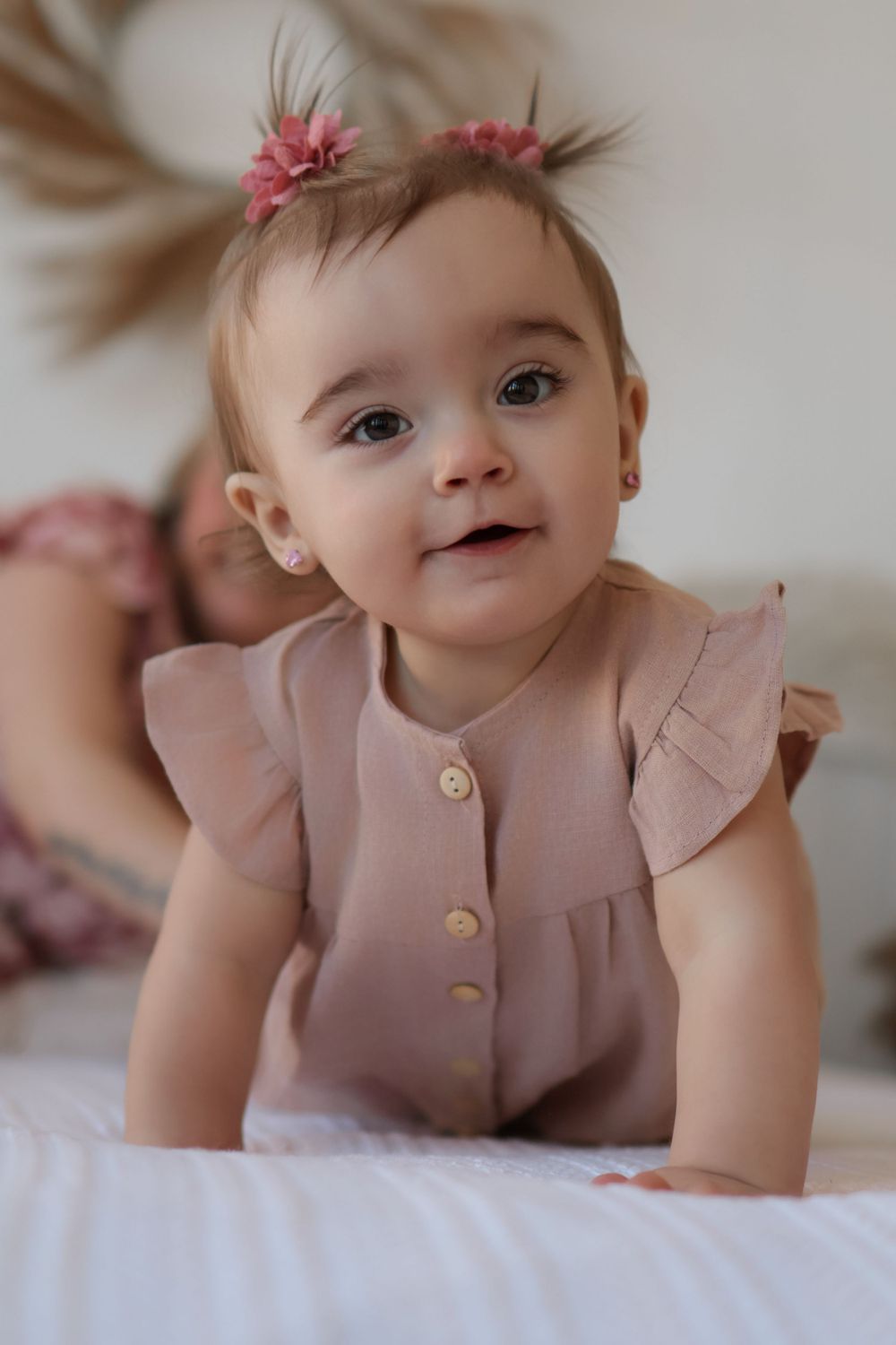 Close-up portrait series showing joyful expressions in a dusty rose outfit.