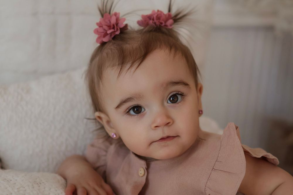 Candid moments captured in soft lighting wearing a dusty rose ensemble.