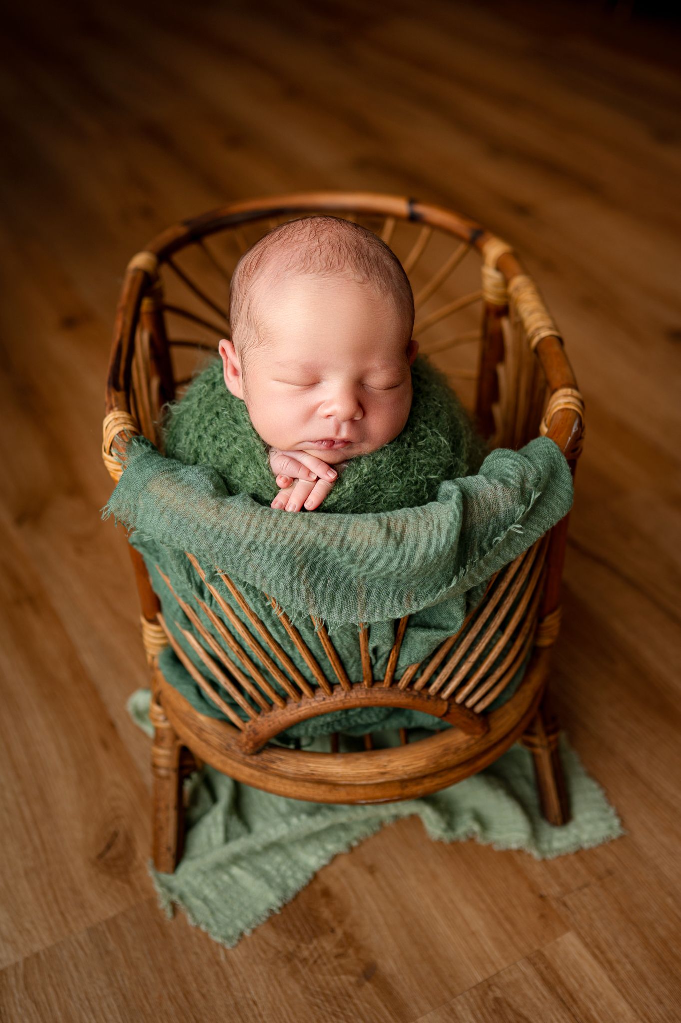 A collection grid of newborn babies sleeping peacefully in soft blankets and baskets arranged in neat rows on beige background.