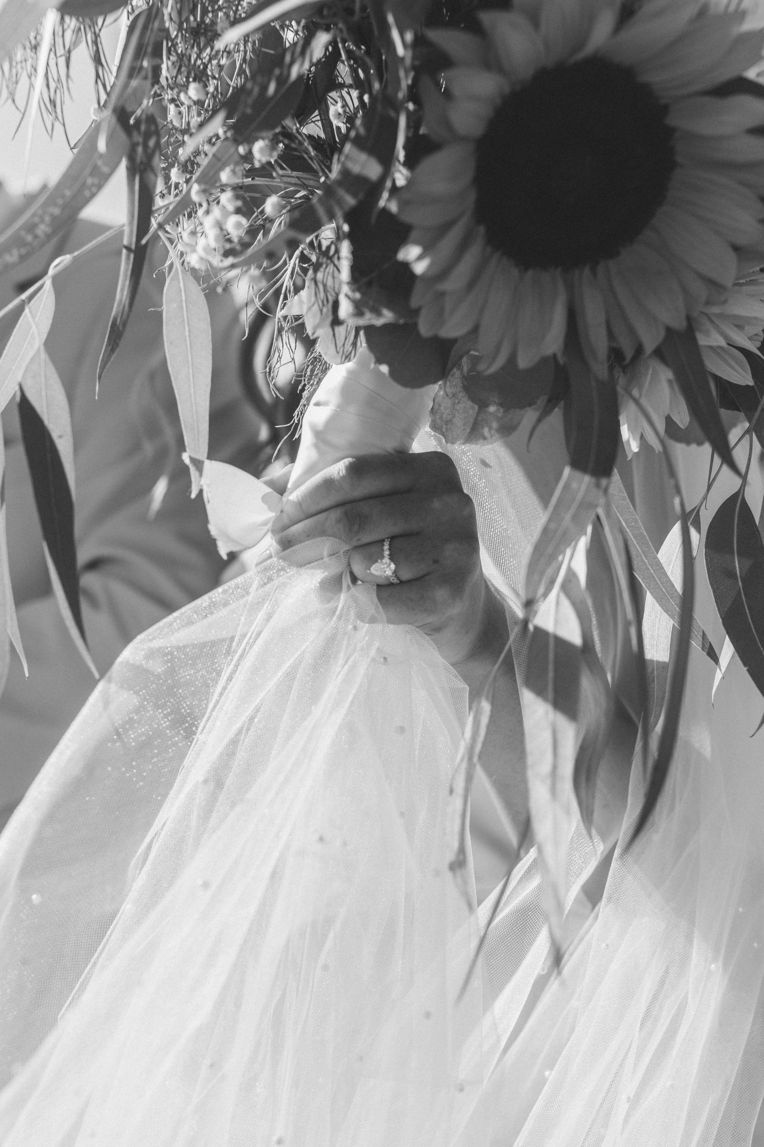 Black and white romantic wedding portrait on a mountain summit with scenic valley views.