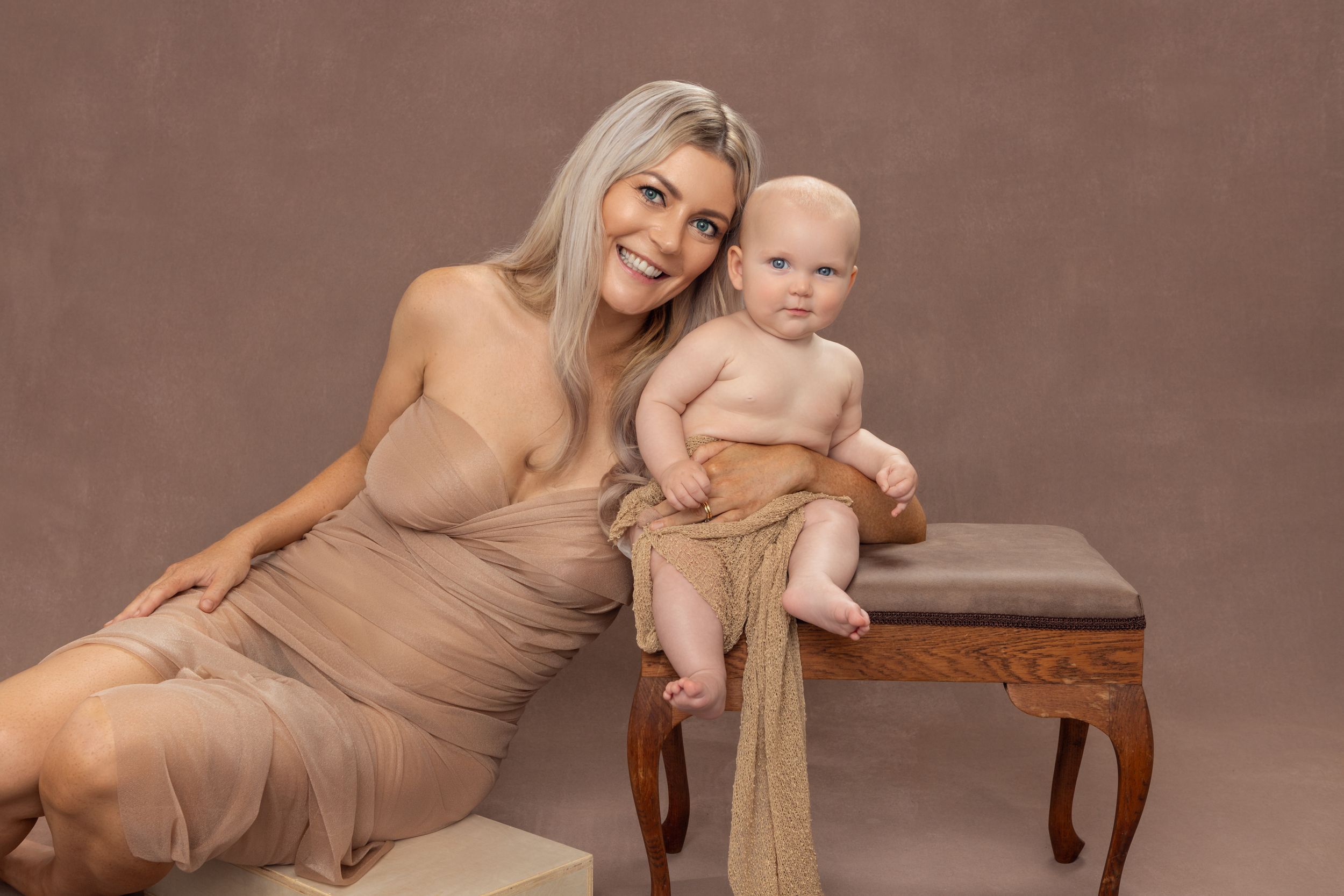 Elegant studio portrait designed to show com=nnection between mother and baby