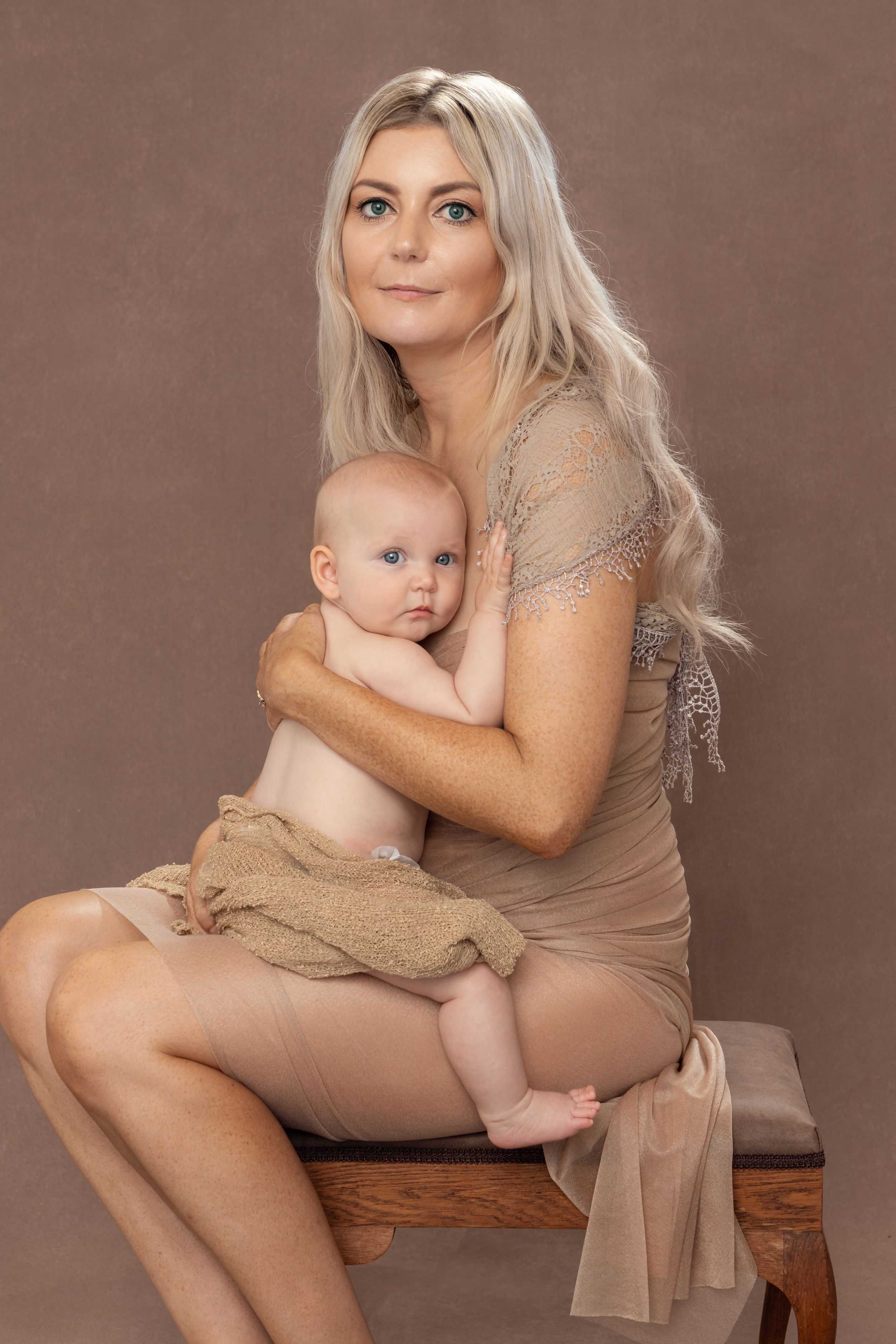 Elegant studio portrait designed to show com=nnection between mother and baby