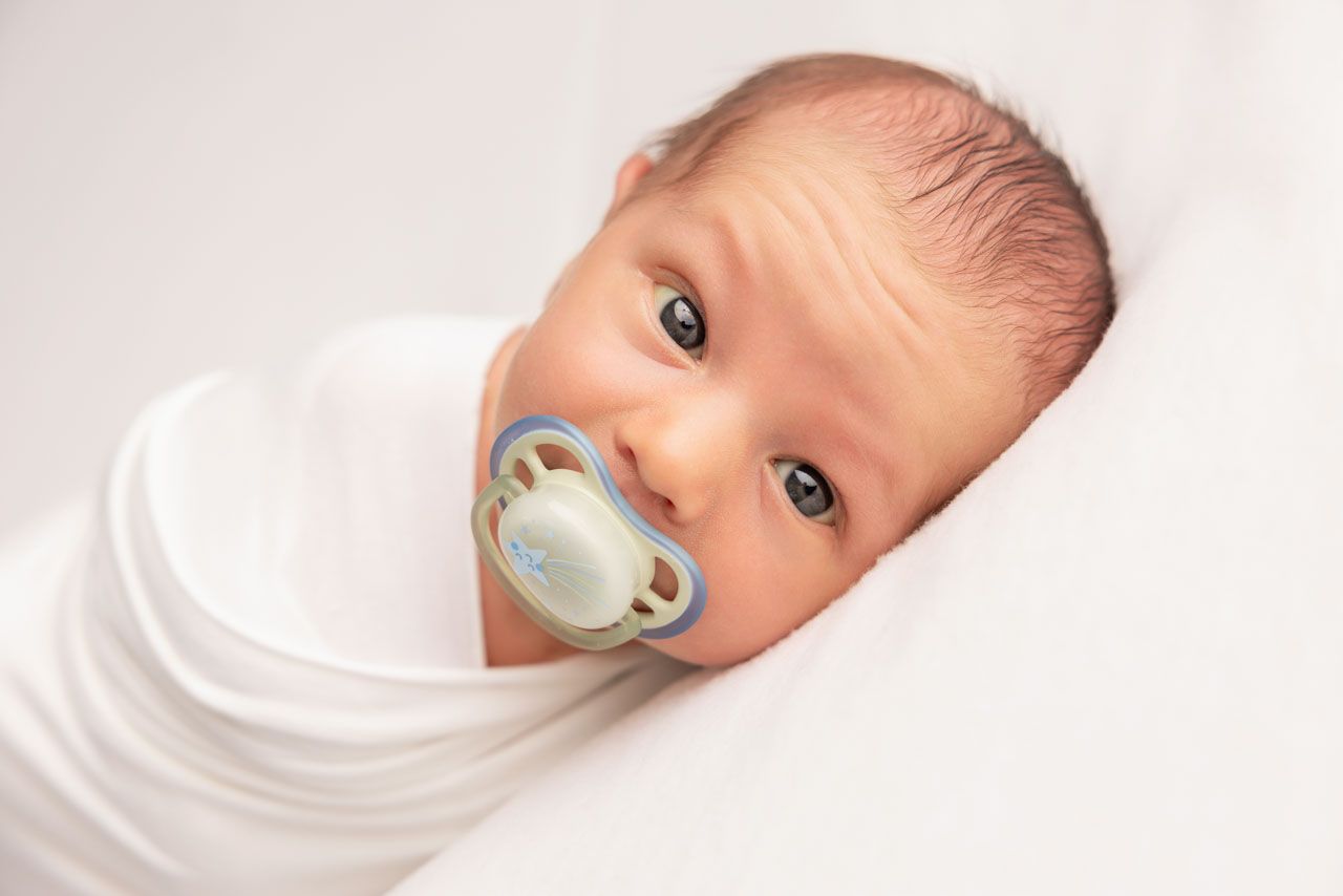 Baby boy portrait, wrapped in white