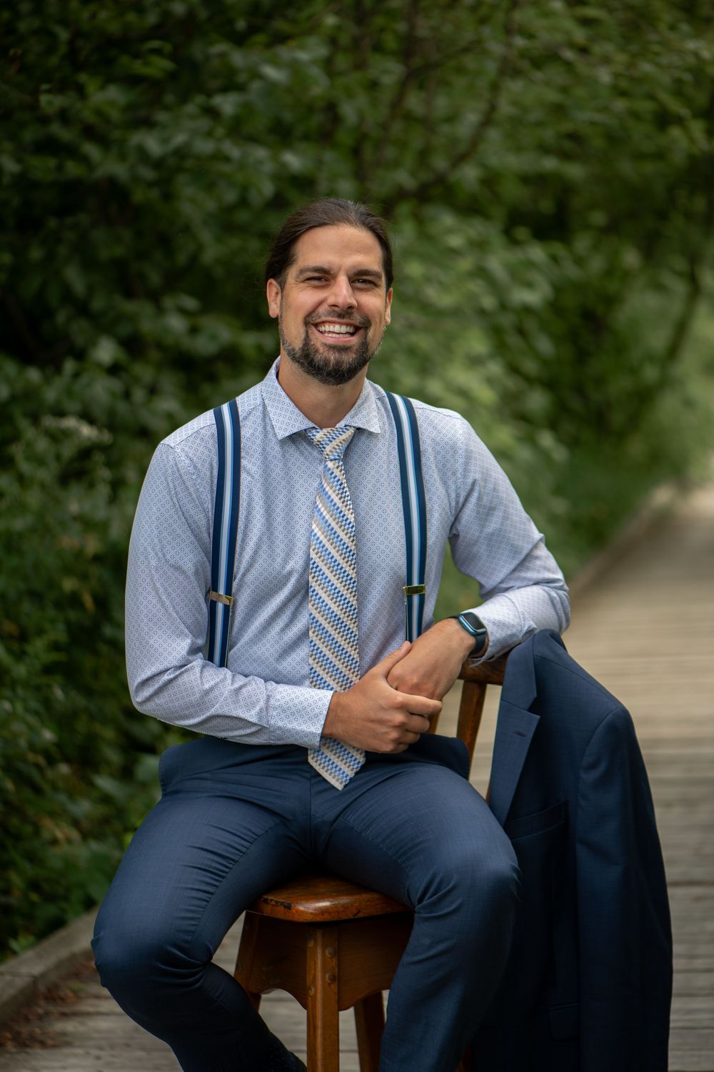 Professional formal portrait series showing a business casual outfit with blue dress shirt, tie and suspenders.