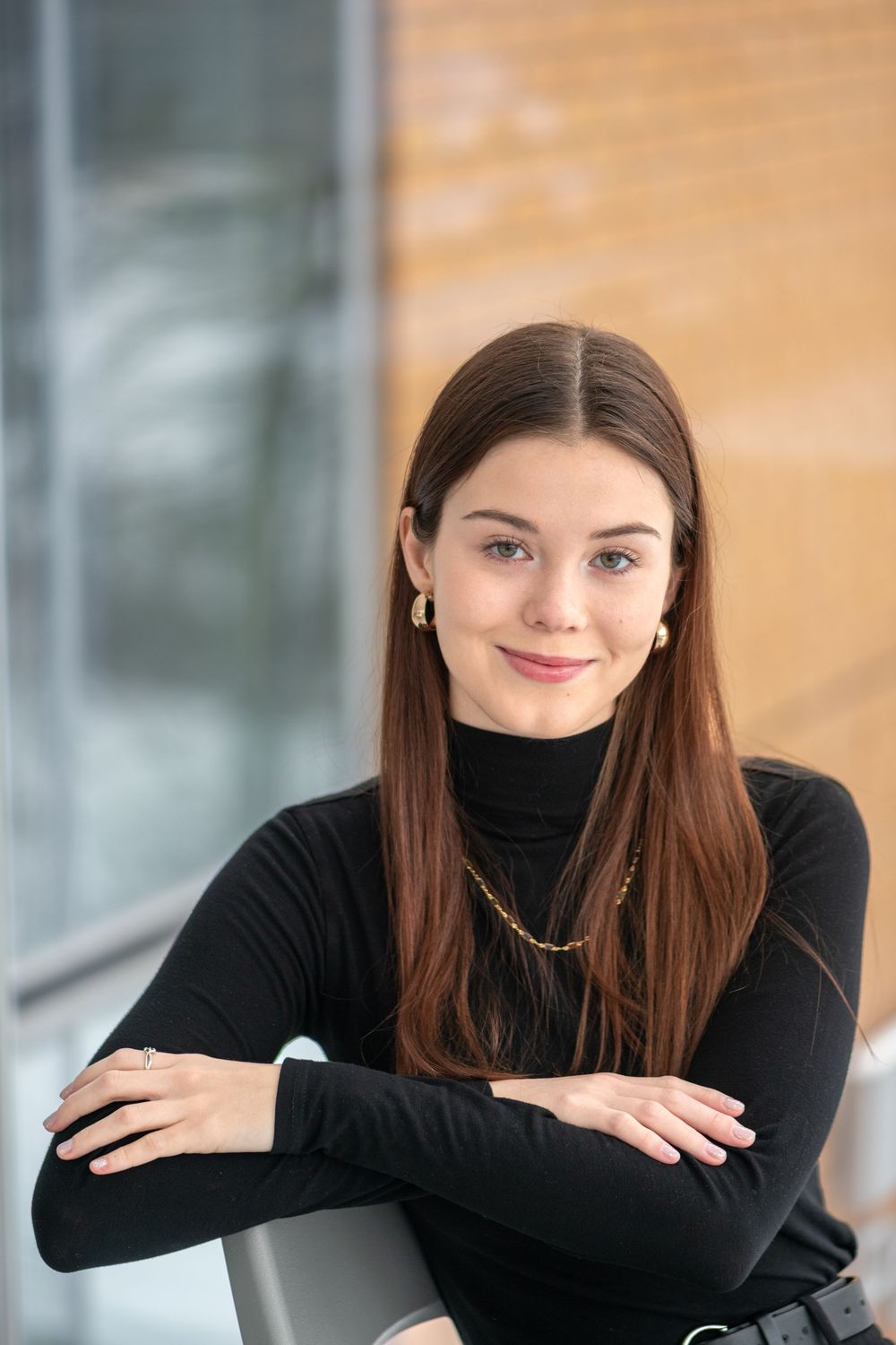 Portrait series showing different poses in a black turtleneck against a warm-toned background.