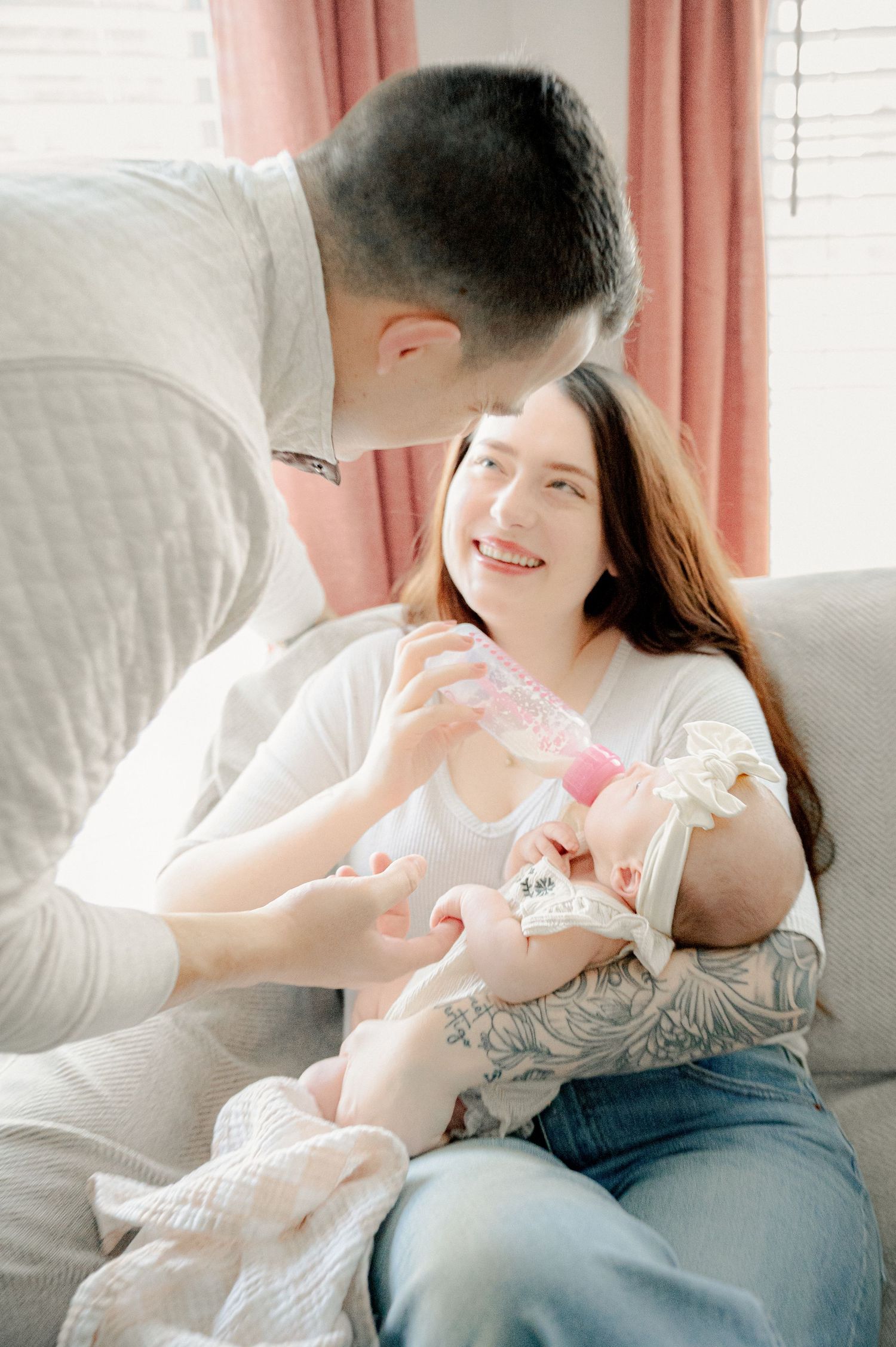 Sweet interaction between family members on a light-filled couch.