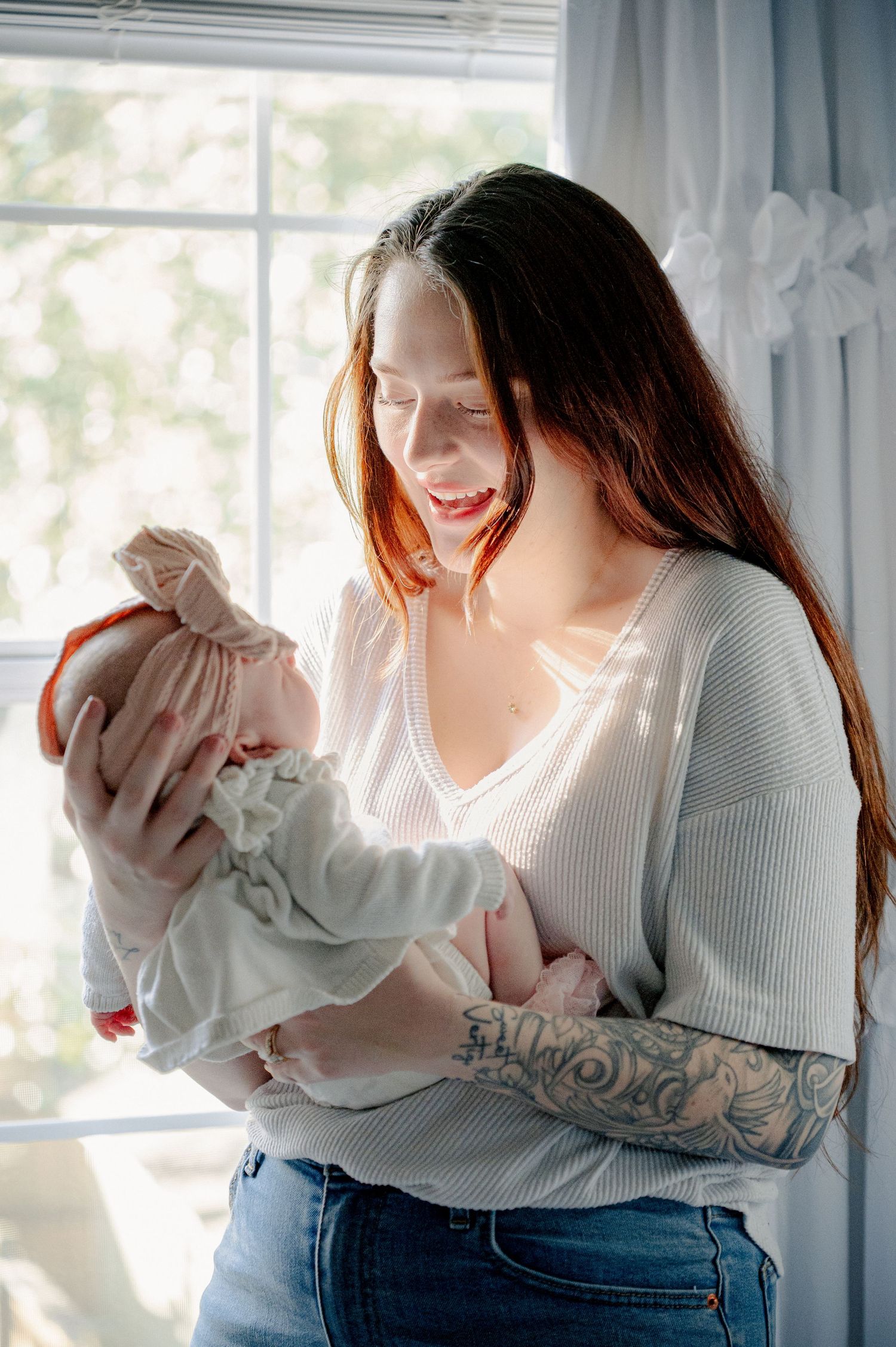 Sunlit indoor photoshoot showing tender moments with a baby.