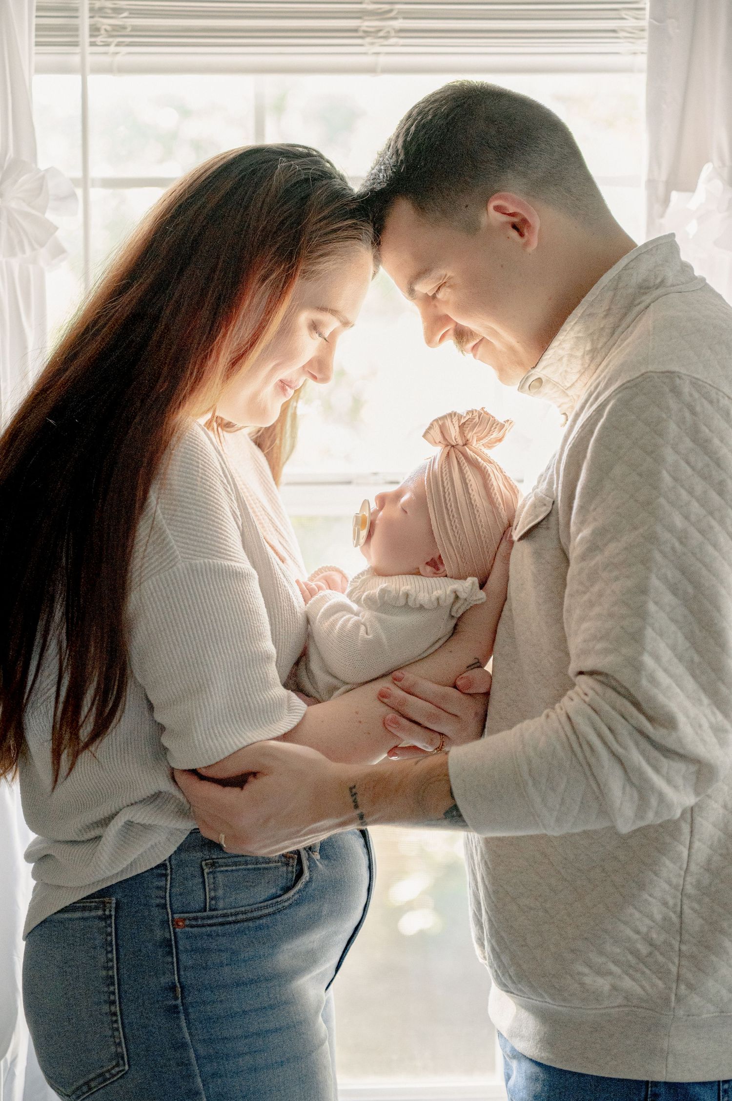 Intimate family moment captured in a bright, airy room.