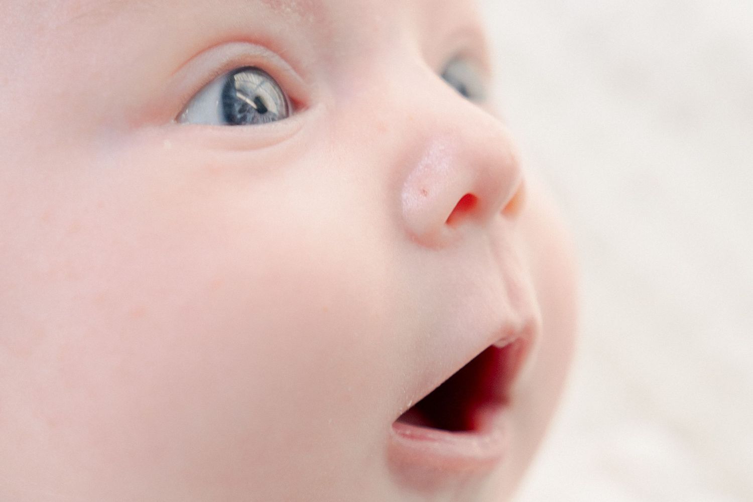 Macro shot of an infant's nose and mouth in dreamy lighting.