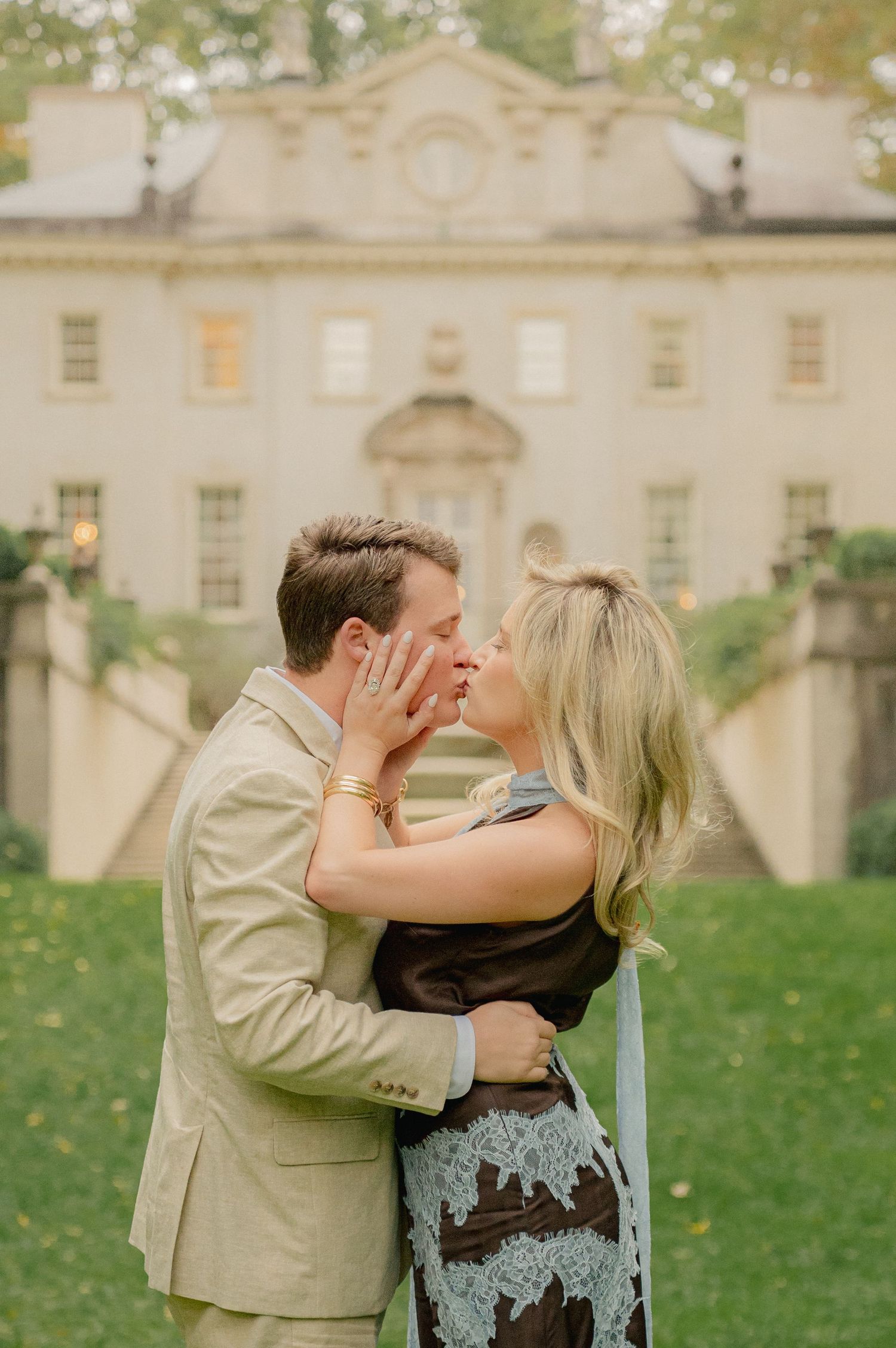 Romantic engagement photos captured in sequence outside historic white stone mansion.