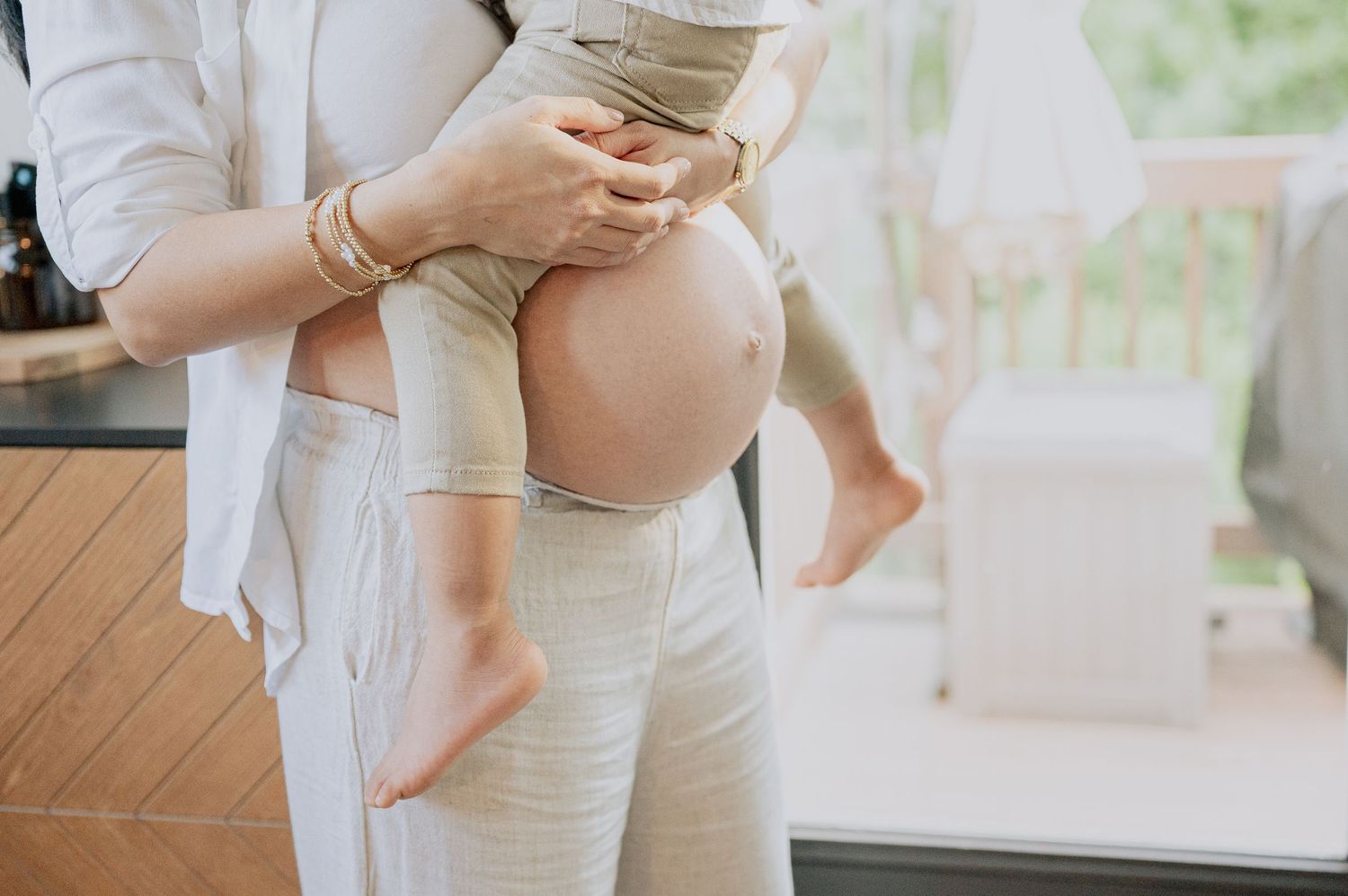 Intimate maternity moments captured in bright white modern interior.
