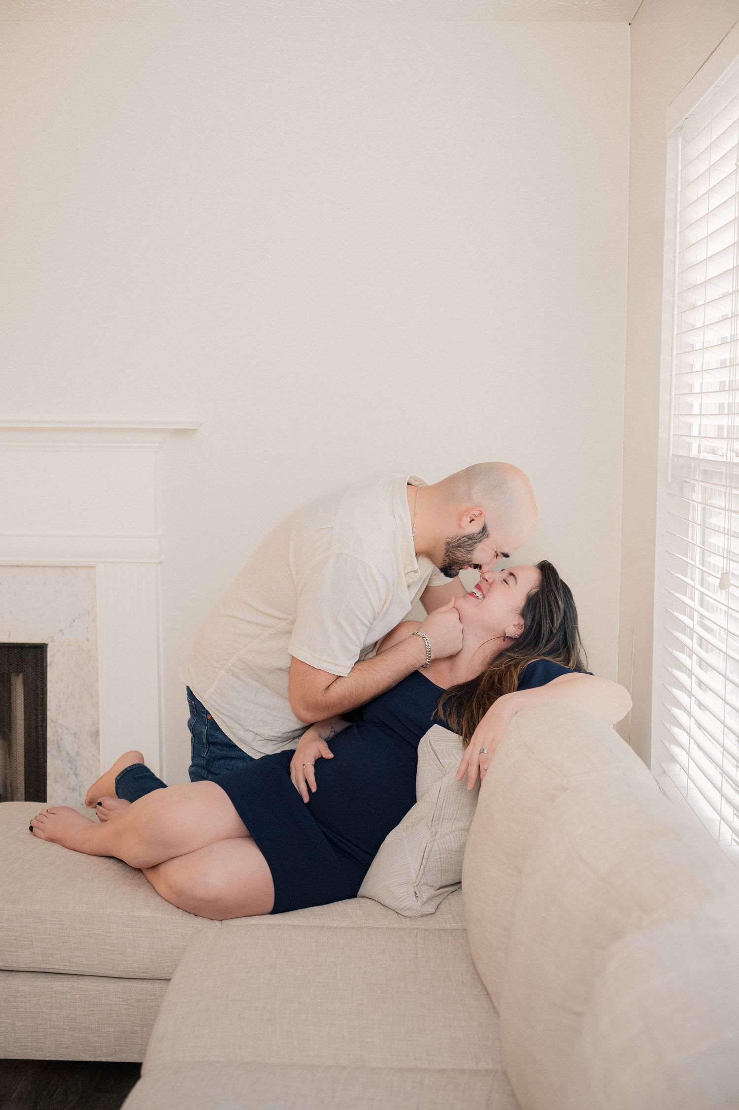 Relaxed scene on a plush beige couch in a sunlit room.