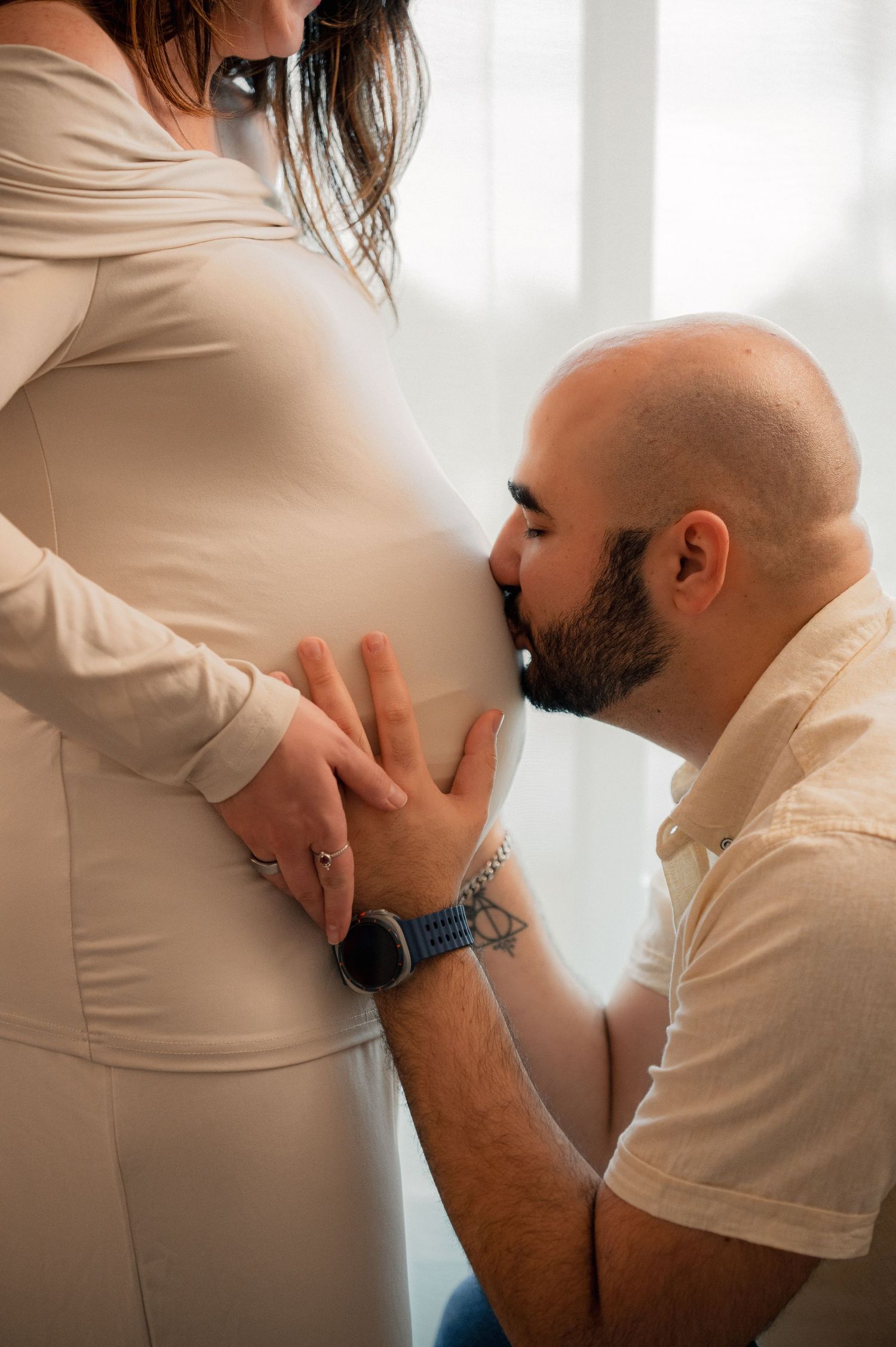 A series of intimate maternity photos showing tender moments in a light-filled room.