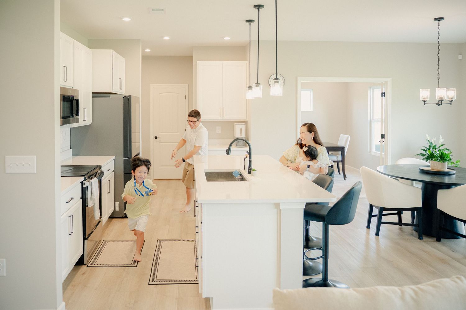 Series of candid family moments photographed in an open concept modern kitchen.