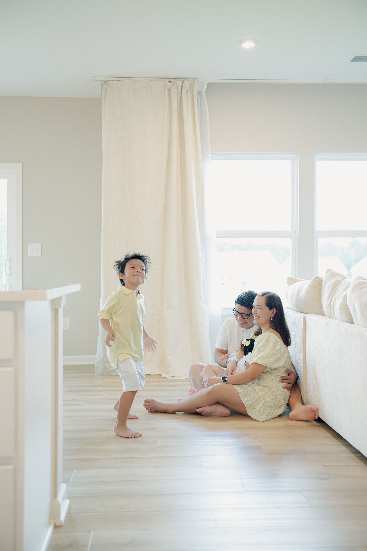 Casual family photos showing relaxed moments on white furniture in a bright modern space.