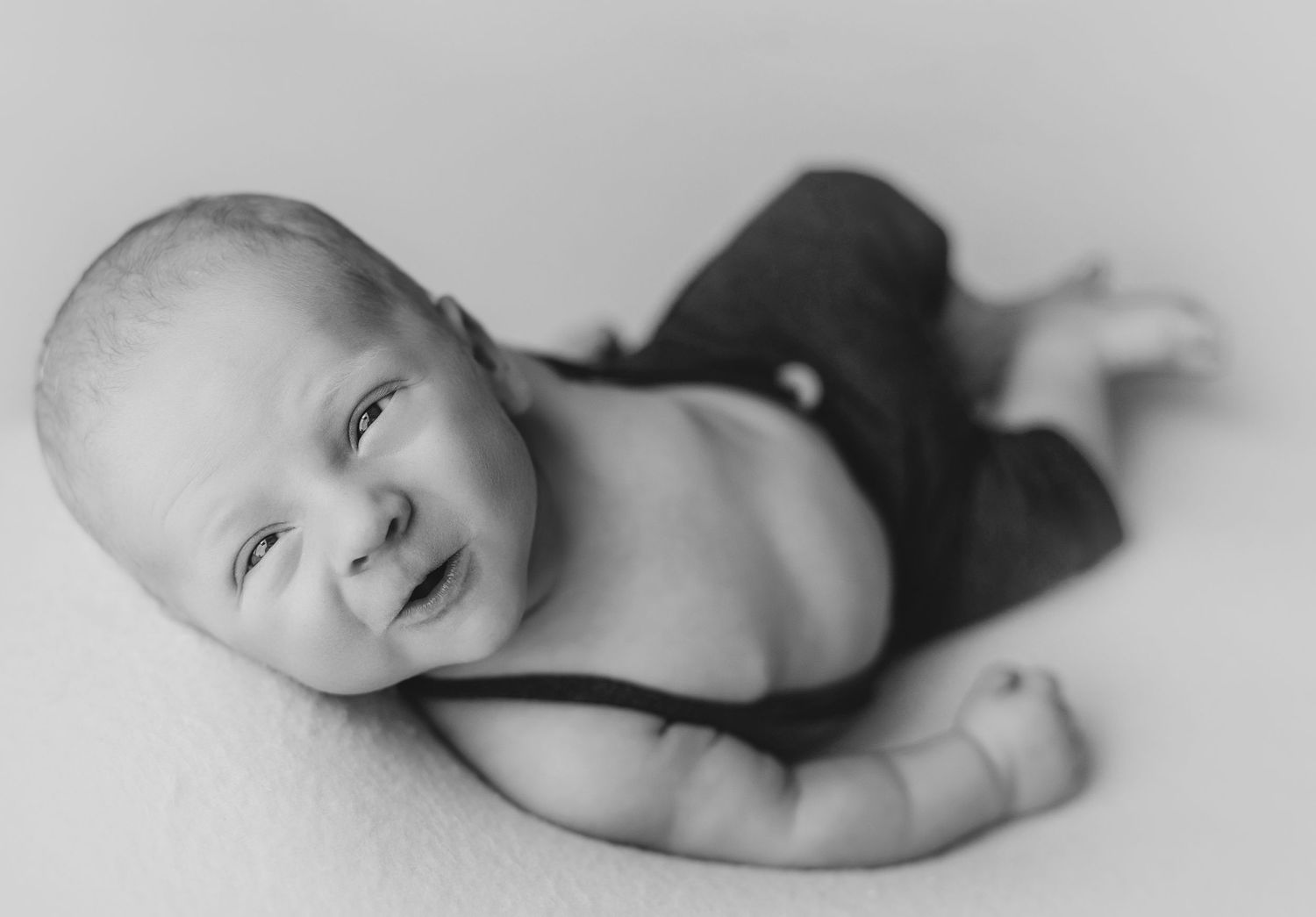 A black and white image showing the huckfin pose. Greenville SC newborn photographer, Easley SC newborn photographer