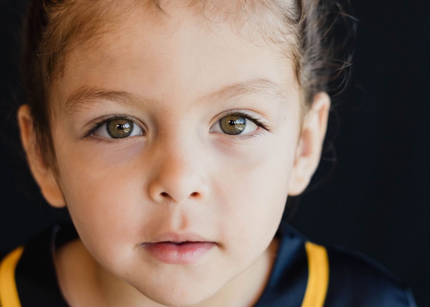 Boy with soft smile in daycare center during a fine art portrait session in Palm Bay.