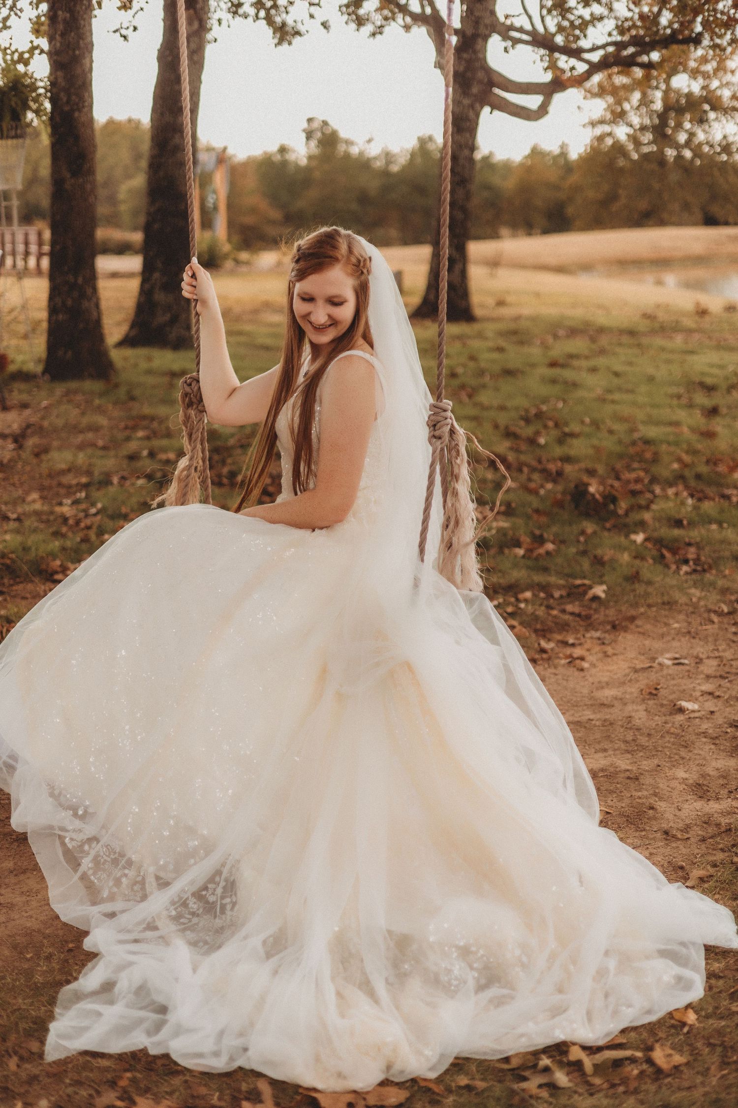 Flowing white wedding dress twirling in an autumn outdoor setting.