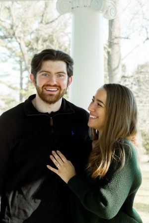 A joyful couple shares a loving moment while posing for their engagement photo.