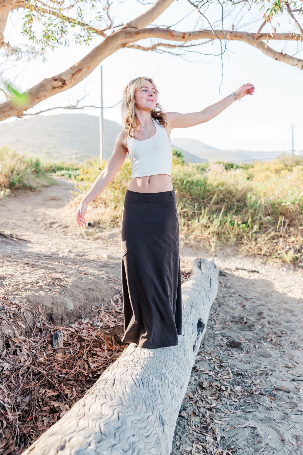 Royal High School graduate posing at Leo Carrillo State Beach in Los Angeles County for stunning outdoor graduation portraits.