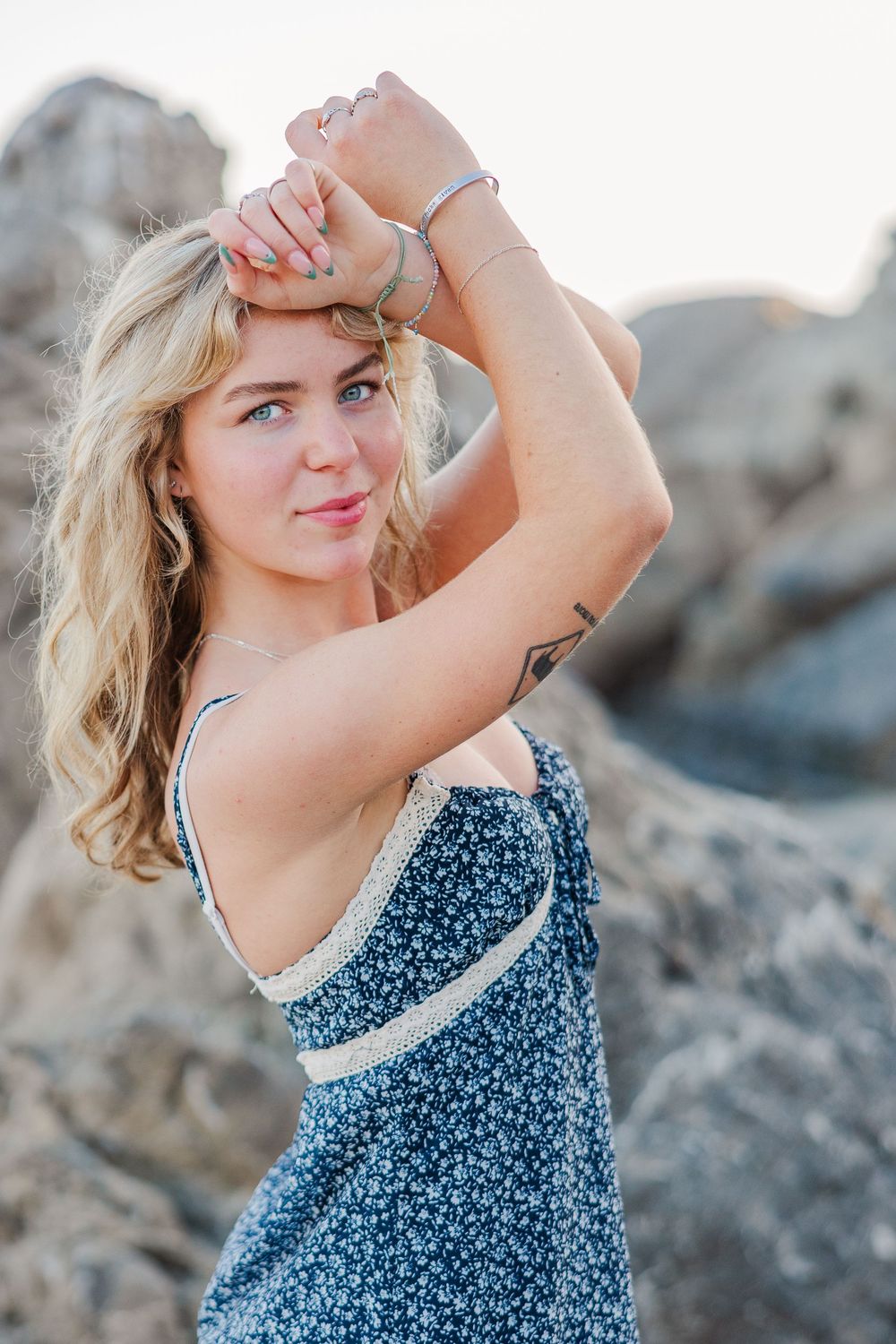 Royal High School graduate posing at Leo Carrillo State Beach in Los Angeles County for stunning outdoor graduation portraits.