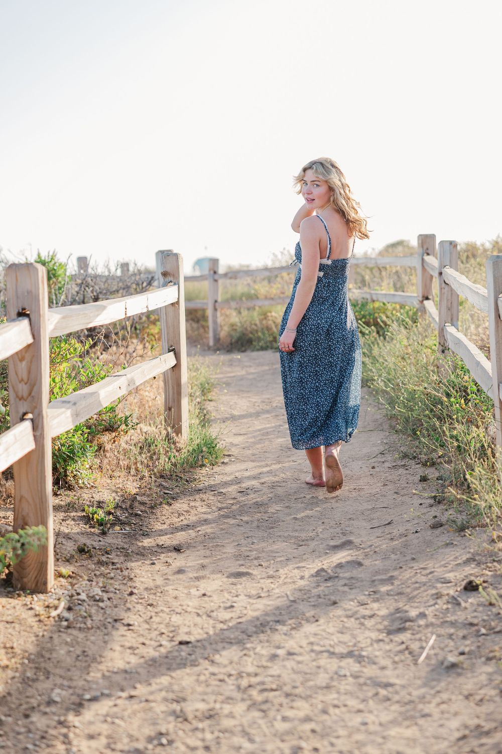 Royal High School graduate posing at Leo Carrillo State Beach in Los Angeles County for stunning outdoor graduation portraits.
