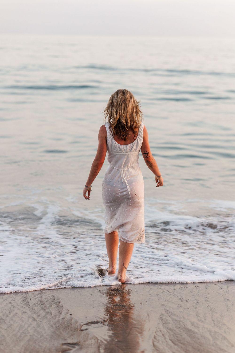 Royal High School graduate posing at Leo Carrillo State Beach in Los Angeles County for stunning outdoor graduation portraits.