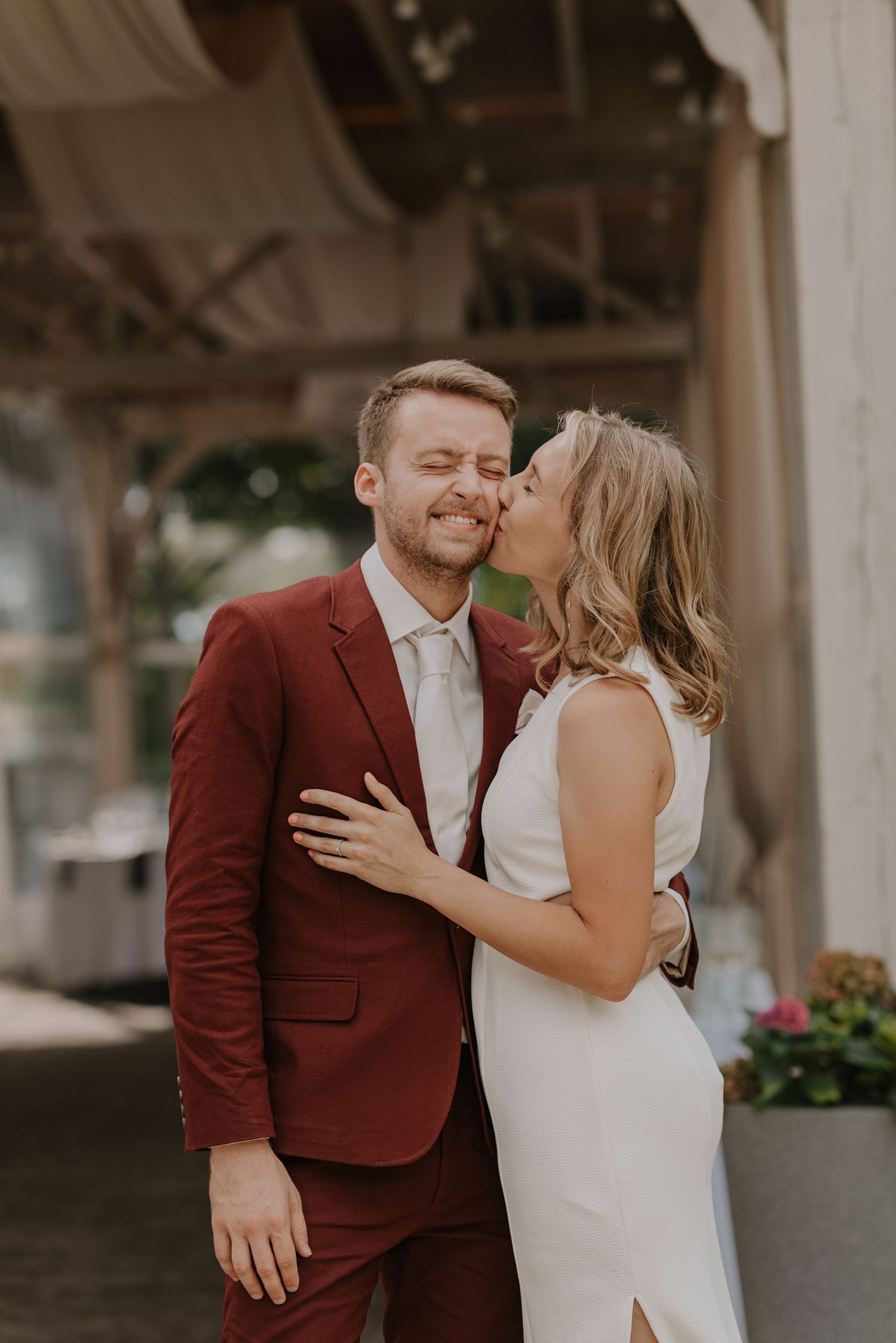 A series of candid wedding moments captured under an architectural overhang.